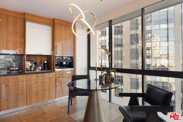 dining room featuring light parquet floors and a notable chandelier