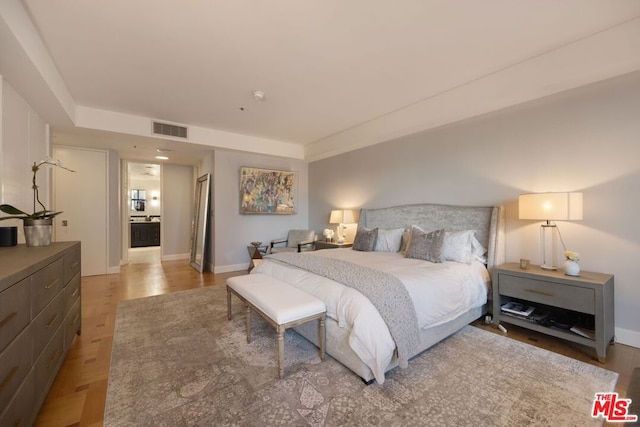 bedroom with light parquet floors