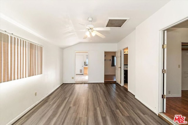 unfurnished room with dark hardwood / wood-style floors, vaulted ceiling, and ceiling fan