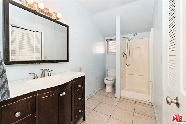 bathroom with toilet, tile patterned flooring, walk in shower, and vanity