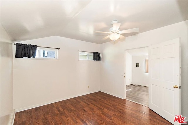 unfurnished room with dark hardwood / wood-style floors, vaulted ceiling, and ceiling fan