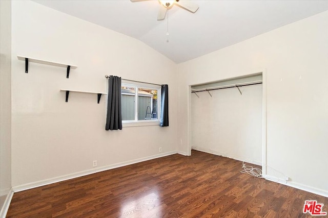 unfurnished bedroom with a closet, ceiling fan, vaulted ceiling, and dark wood-type flooring