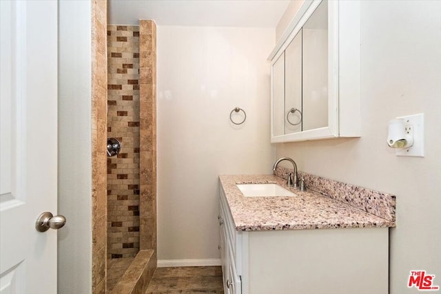 bathroom featuring vanity and a tile shower