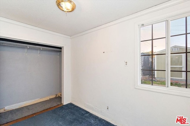 unfurnished bedroom featuring a closet, carpet, and ornamental molding