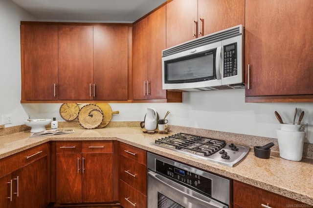 kitchen featuring light stone counters and appliances with stainless steel finishes