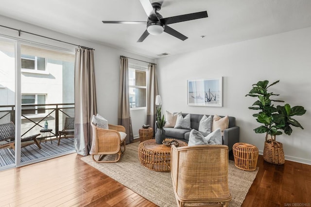 living room featuring hardwood / wood-style flooring and ceiling fan