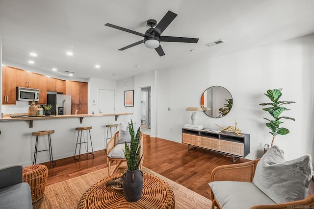 living room featuring light hardwood / wood-style flooring and ceiling fan