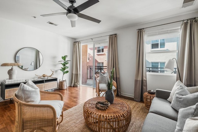 sitting room with hardwood / wood-style flooring, a healthy amount of sunlight, and ceiling fan