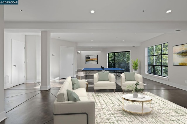 living room with concrete floors and beamed ceiling