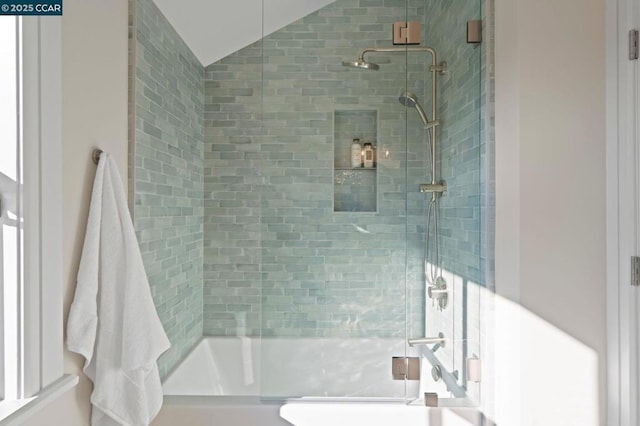 bathroom with combined bath / shower with glass door and vaulted ceiling