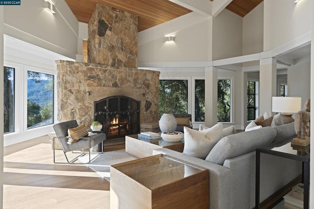 living room featuring hardwood / wood-style floors, a fireplace, wooden ceiling, high vaulted ceiling, and beam ceiling