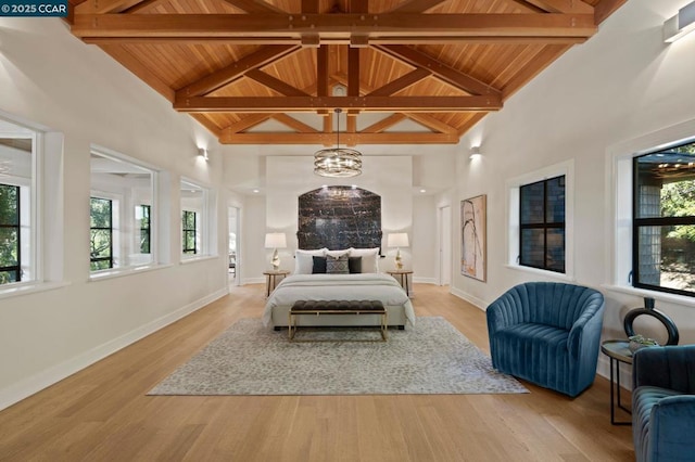 bedroom with high vaulted ceiling, wooden ceiling, light hardwood / wood-style flooring, and beam ceiling