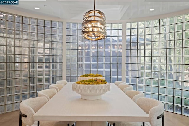 dining area featuring beamed ceiling, expansive windows, a notable chandelier, and coffered ceiling