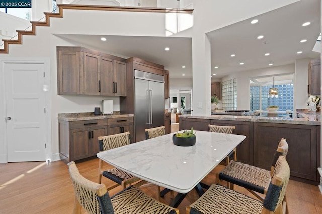 dining space with a wealth of natural light and light hardwood / wood-style floors