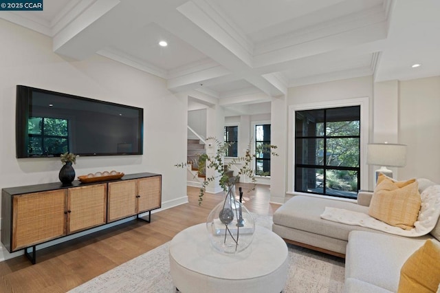 living room featuring hardwood / wood-style floors, coffered ceiling, beamed ceiling, and ornamental molding