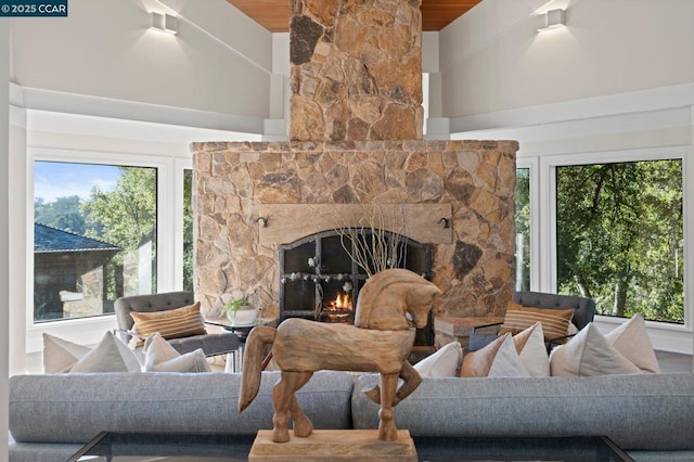 living room featuring vaulted ceiling with beams, wood ceiling, and a fireplace