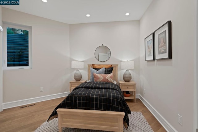 bedroom with wood-type flooring