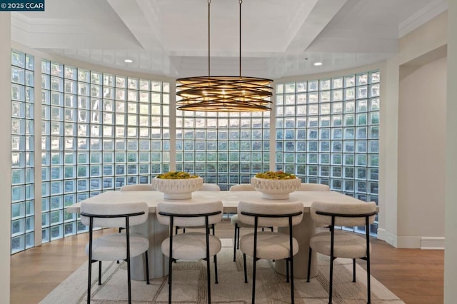 dining space with hardwood / wood-style floors, beam ceiling, and expansive windows