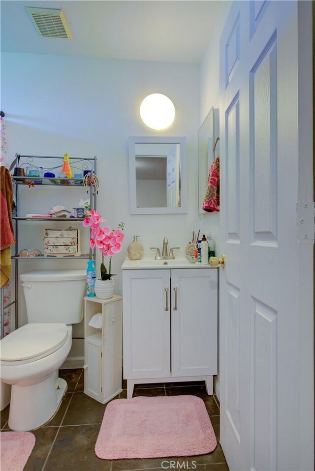 bathroom with tile patterned floors, vanity, and toilet