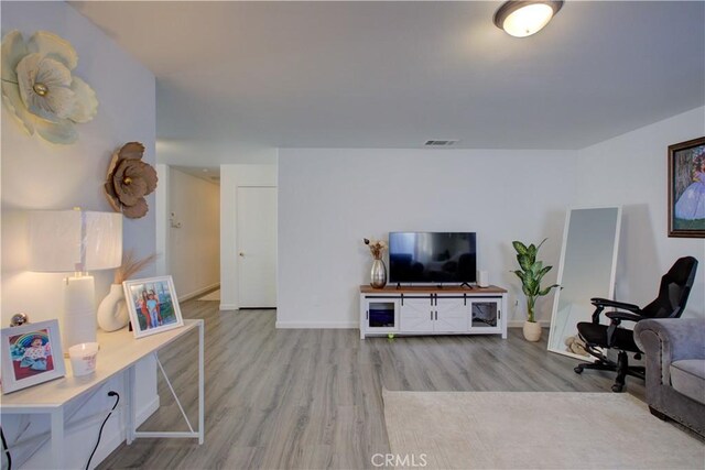 living room with light hardwood / wood-style flooring