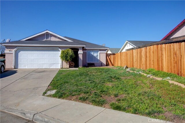 view of front of property featuring a garage and a front yard