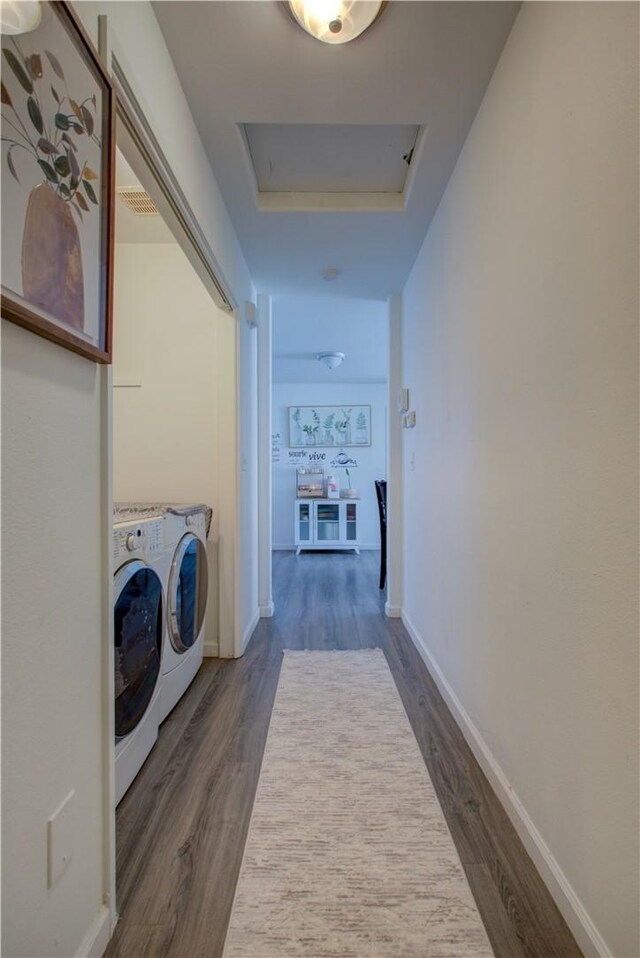 laundry area with dark hardwood / wood-style floors and separate washer and dryer