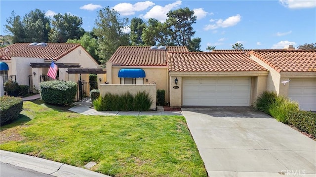 mediterranean / spanish-style house featuring a garage and a front yard