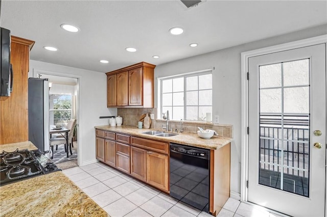 kitchen with sink, backsplash, black appliances, and light tile patterned floors