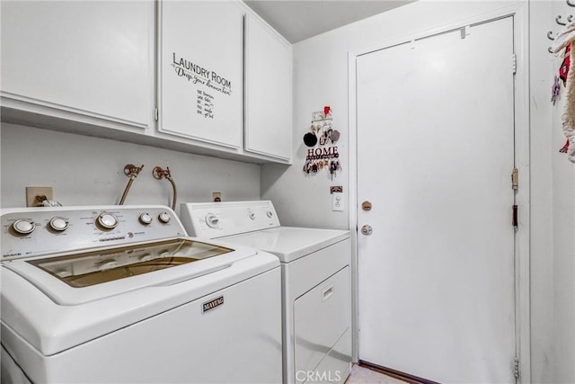 laundry room featuring cabinets and separate washer and dryer