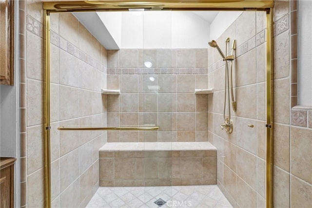 bathroom featuring a shower with door