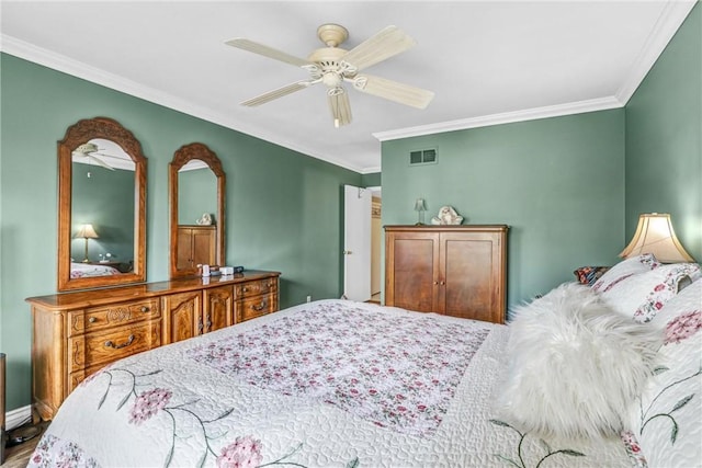 bedroom with ceiling fan and ornamental molding