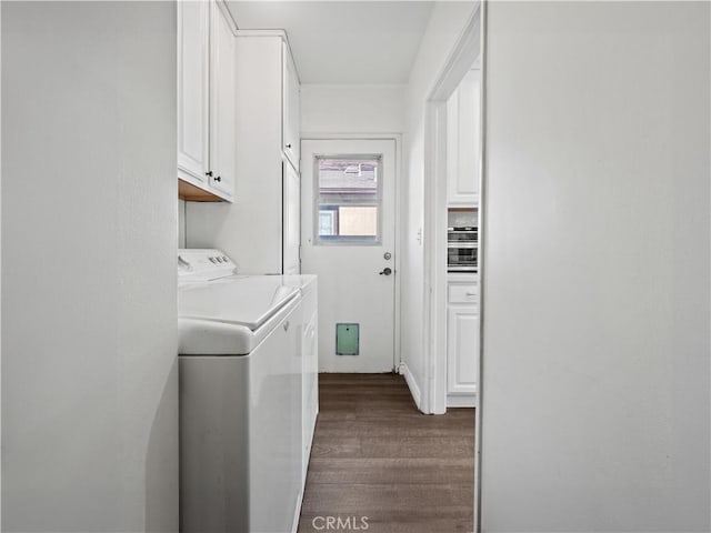 laundry area with cabinets, dark hardwood / wood-style floors, and washing machine and clothes dryer