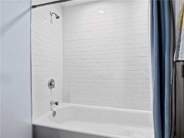 bathroom with shower / bath combo with shower curtain