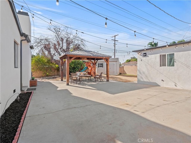 view of patio with a gazebo and a storage unit