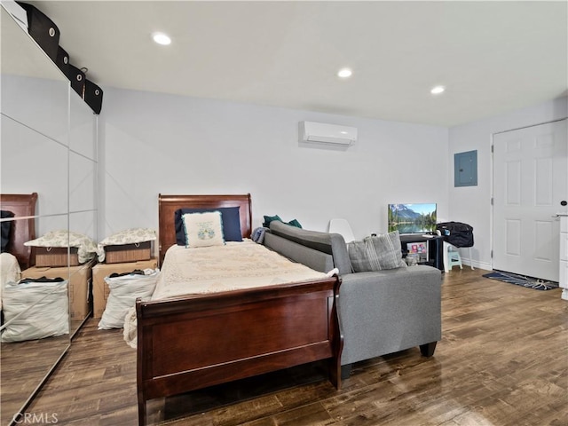 bedroom with an AC wall unit, electric panel, and dark wood-type flooring