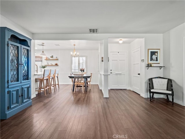 foyer featuring dark wood-type flooring and a notable chandelier