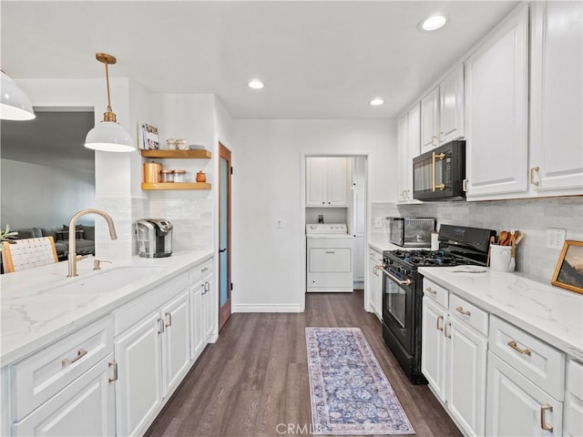 kitchen featuring hanging light fixtures, sink, washer / clothes dryer, white cabinetry, and black appliances