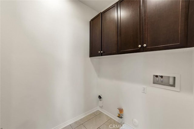 washroom with cabinets, gas dryer hookup, washer hookup, and light tile patterned floors