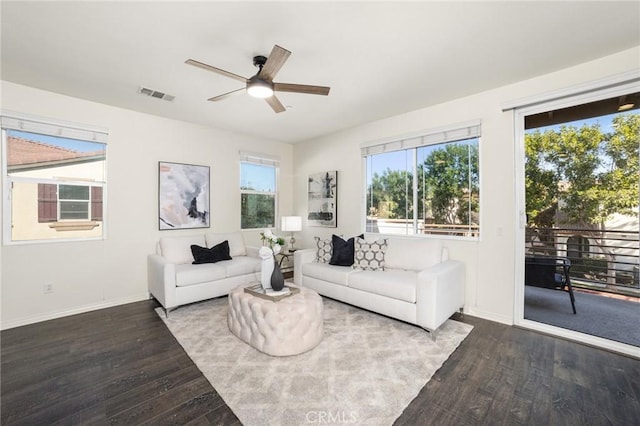 living room featuring ceiling fan and dark hardwood / wood-style floors