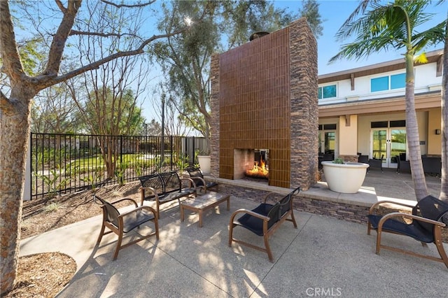 view of patio featuring an outdoor living space with a fireplace