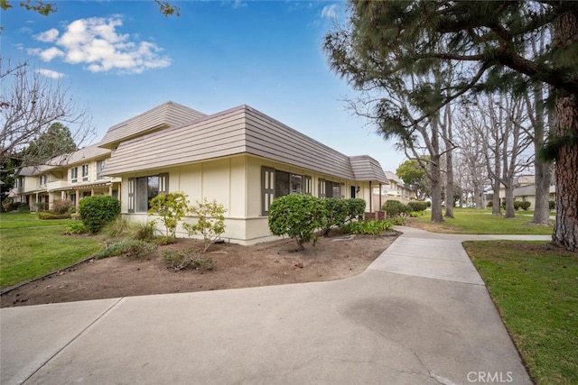 view of property exterior with a lawn