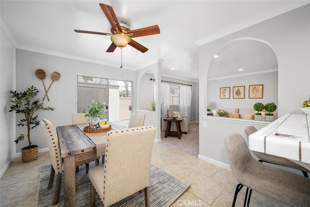 dining space with light tile patterned floors, ornamental molding, and ceiling fan