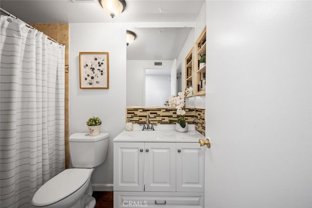 bathroom with vanity, backsplash, and toilet