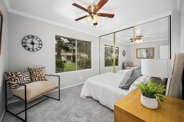 bedroom with ornamental molding, light colored carpet, ceiling fan, and a closet