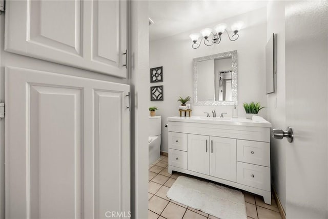 bathroom featuring tile patterned flooring, vanity, and toilet