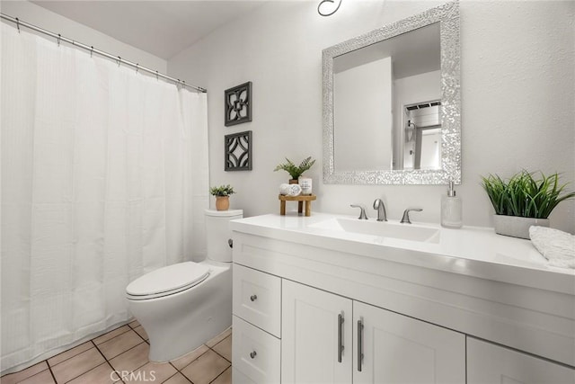 bathroom with tile patterned floors, toilet, and vanity