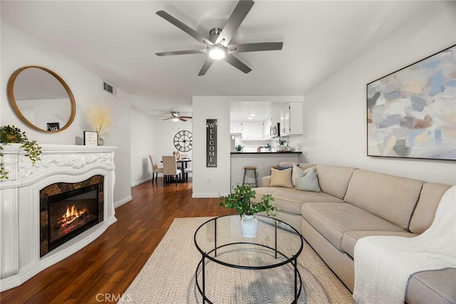 living room with ceiling fan and dark hardwood / wood-style floors