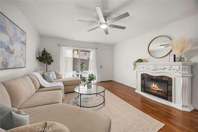 living room featuring ceiling fan and dark hardwood / wood-style flooring