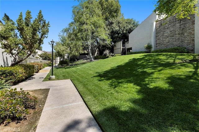 view of property's community with a lawn