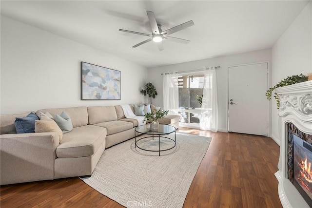 living room featuring dark hardwood / wood-style flooring and ceiling fan